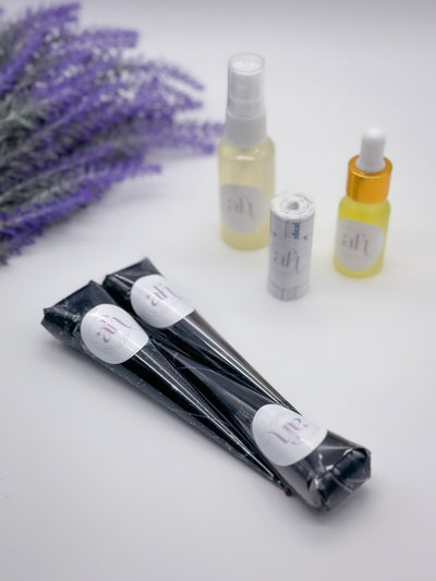 The image shows three Jagua cones with a fine tip, alongside a bottle of Lemon Sugar Sealant Spray and a small bottle of Aftercare Oil, all presented on a white surface with lavender flowers in the background.