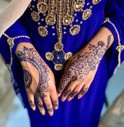 Intricate dark blue-black jagua design on a woman's hand applied using Amarya Henna jagua cones. Perfect for eid inspiration 