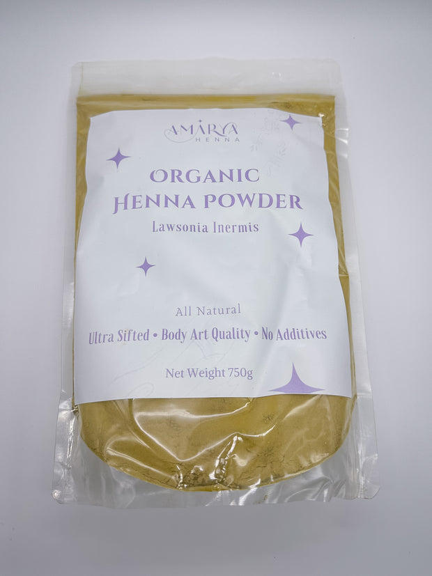 A sealed, clear resealable pouch of Amarya Henna Organic Henna Powder with a white and purple label. The label reads "Amarya Henna," "Organic Henna Powder," "Lawsonia Inermis," and highlights features such as "All Natural," "Ultra Sifted," "Body Art Quality," and "No Additives." The net weight is 250g.