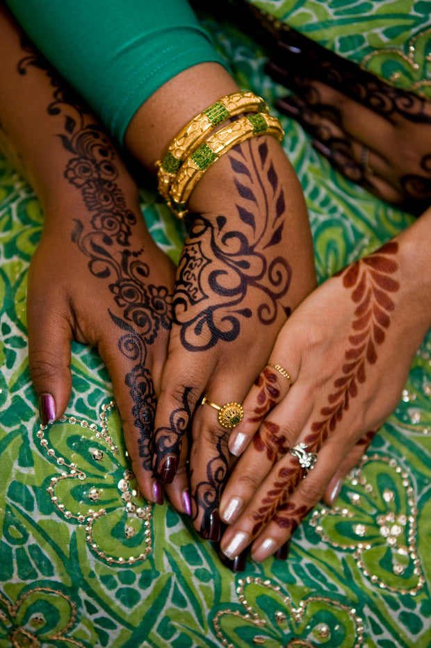 Henna and jagua designs displayed on hands with fair, medium, and dark skin tones, showcasing how the stain appears across different complexions. 