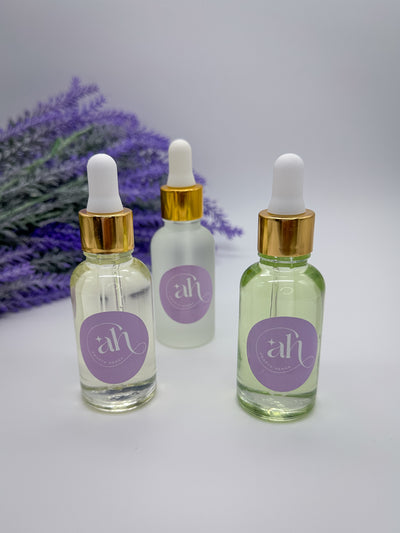 Three glass bottles with droppers filled with Amarya Henna essential oils. The available oils are Cajeput, lavender, and eucalyptus