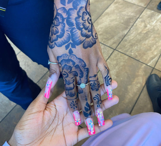 Beautiful floral jagua design with a hint of henna using AmaryaHenna cones on darker skin with decorative pink nails.