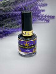 A bottle of Queen Nail Henna in Deep Lavender (Lilac) color with a black cap, placed against a white background with lavender flowers in the background. Sold by Amarya Henna