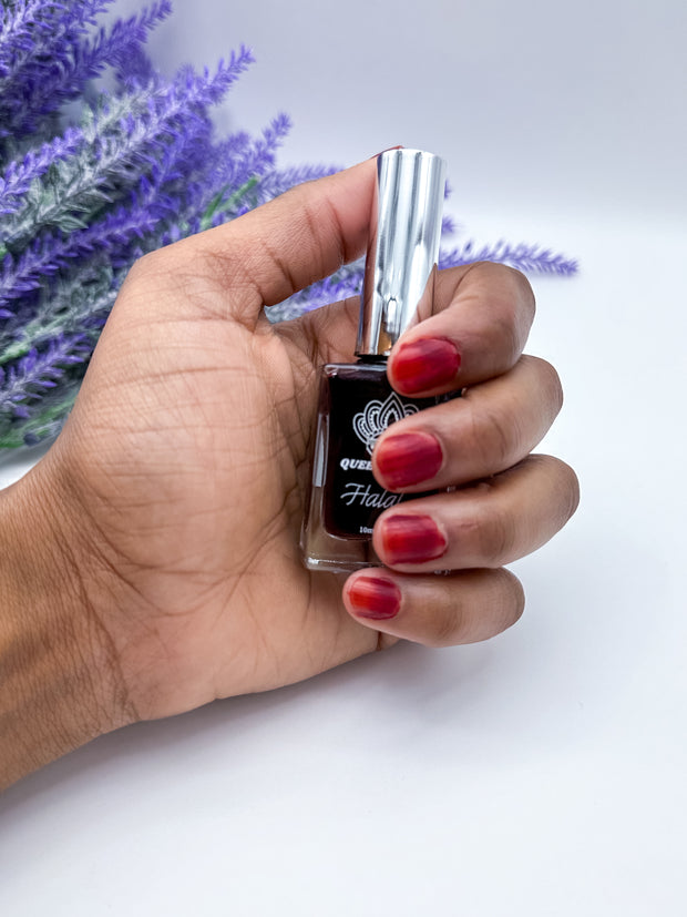 Woman wearing nail stain, holding the bottle. Queen Nail Henna – Maroon | Halal, wudu-friendly, and breathable nail stain | Water-permeable, no enamel or barrier on nail, perfect for prayer | Organic, vegan, and natural alternative to nail polish, henna nail stain - Amarya Henna.